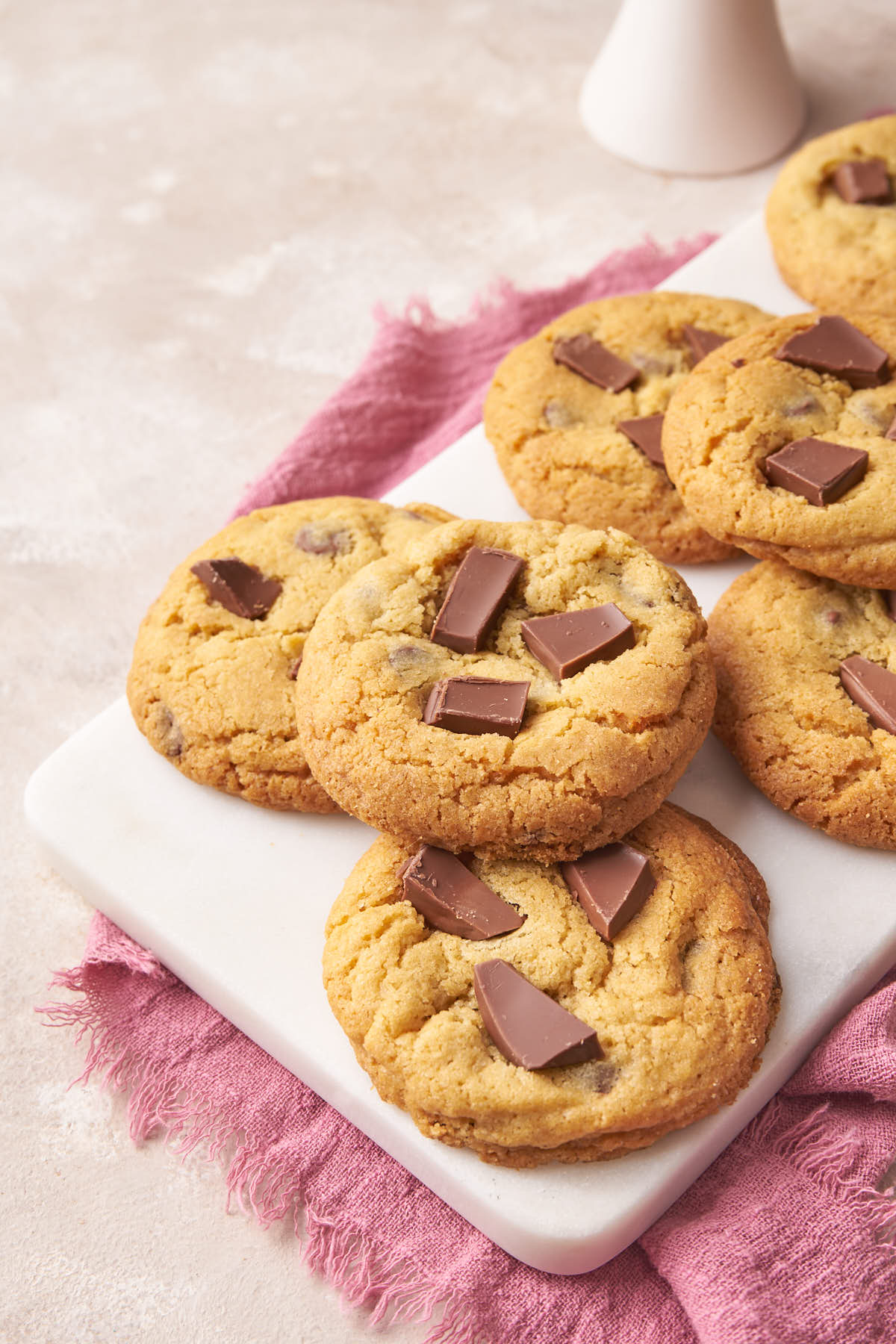 a marble board filled with chocolate chip cookies.